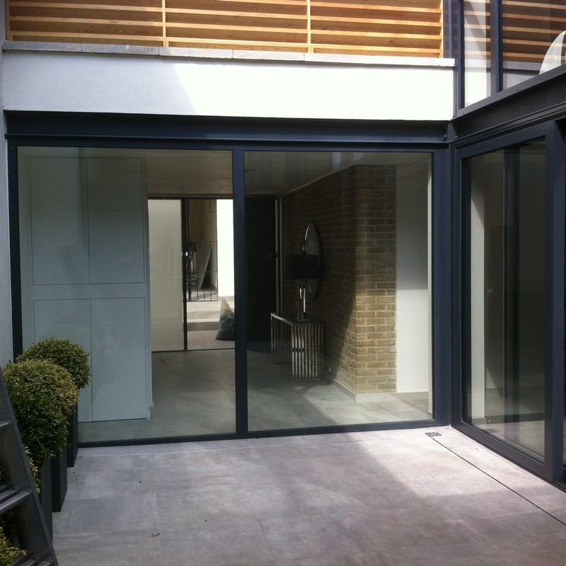 Floor-to-ceiling sliding doors opening to courtyard in Staines-upon-Thames