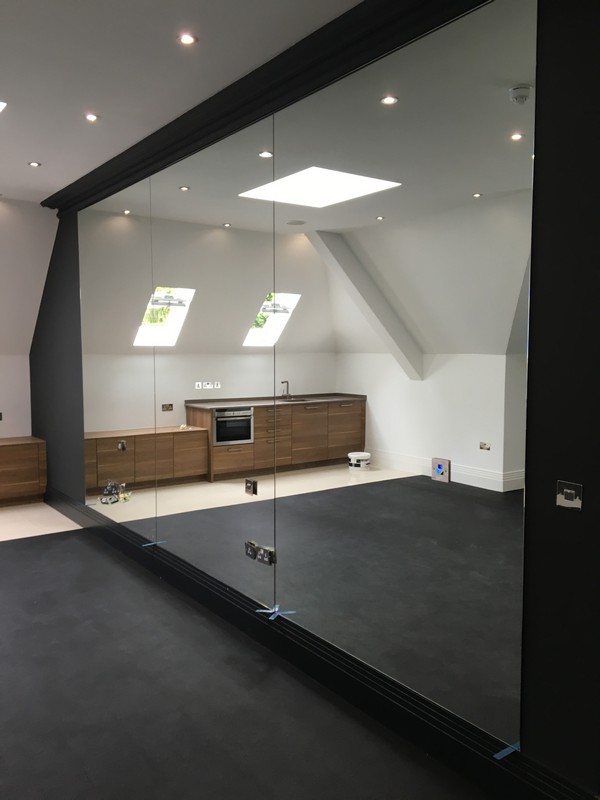 Frameless glass partition in loft conversion by Staines-upon-Thames glaziers