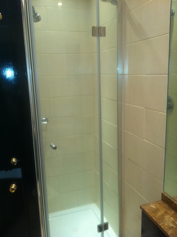 Frameless glass shower enclosure with chrome fittings in Staines-upon-Thames