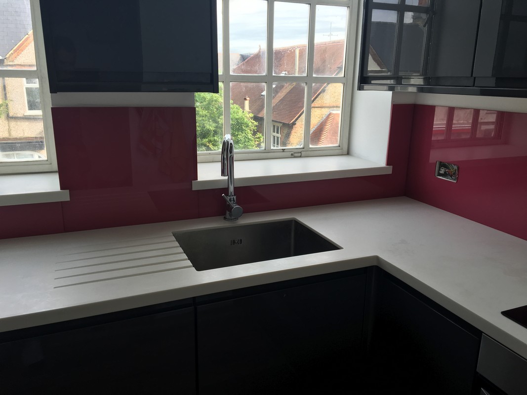Deep plum coloured glass splashback in modern Staines-upon-Thames kitchen